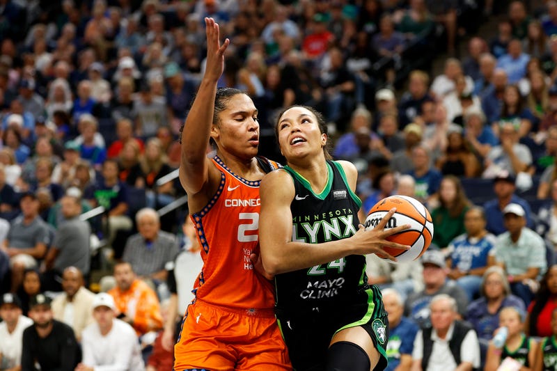 Napheesa Collier #24 of the Minnesota Lynx drives to the basket against Alyssa Thomas #25 of the Connecticut Sun during the WNBA Playoffs at Target Center.