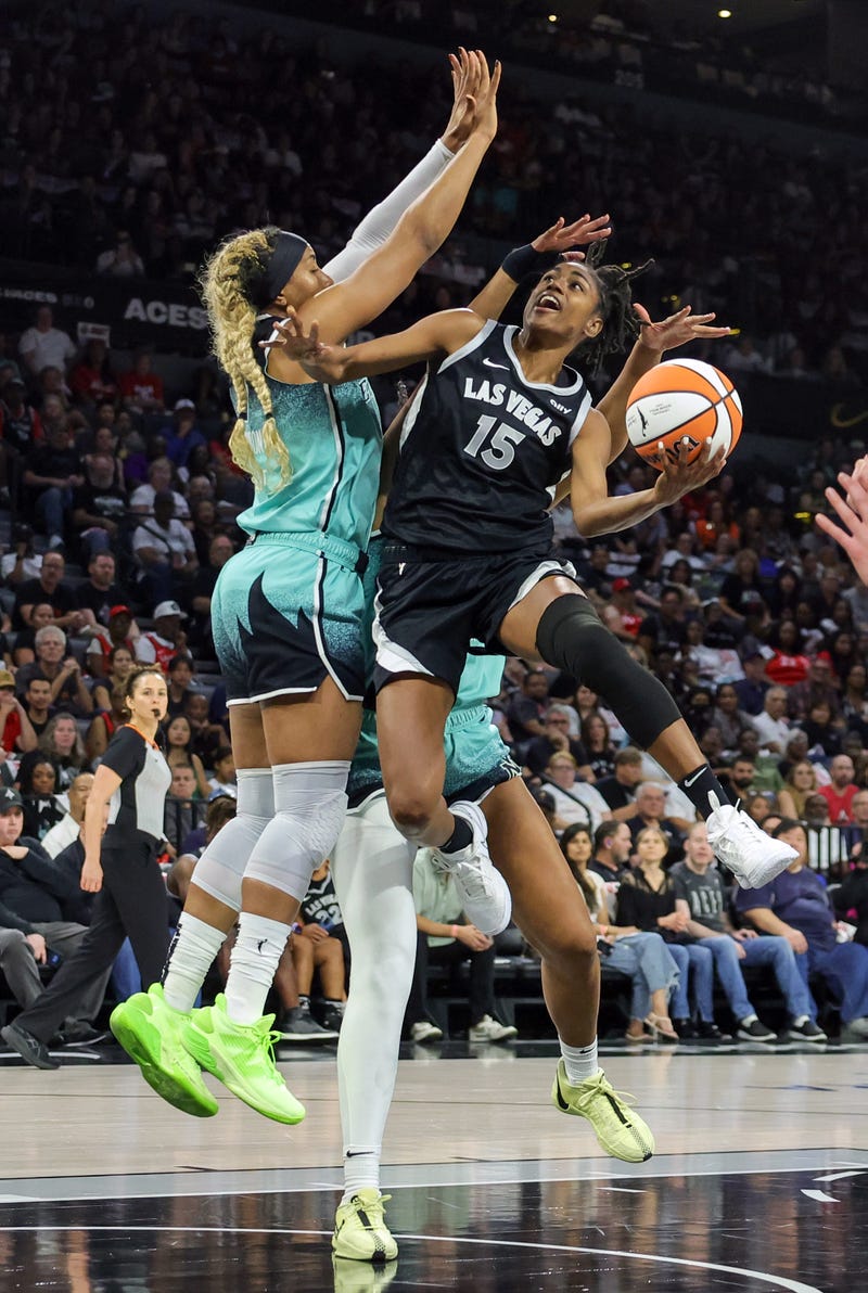 Tiffany Hayes #15 of the Las Vegas Aces shoots against Kayla Thornton (L) #5 and Nyara Sabally #8 of the New York Liberty in the first quarter of Game Three of the 2024 WNBA Playoffs semifinals at Michelob ULTRA Arena on October 04, 2024.