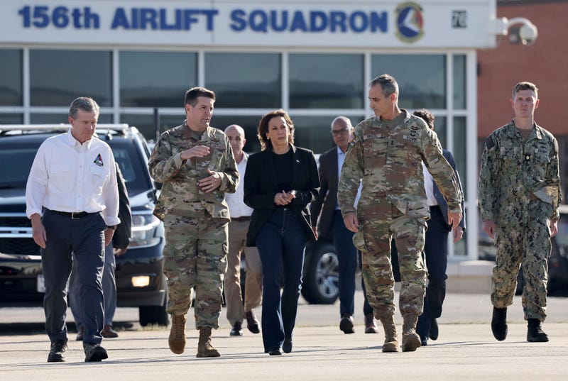 Democratic presidential nominee, Vice President Kamala Harris walks with members of the U.S. Armed Forces and North Carolina Governor Roy Cooper after being briefed on recovery operations at the the Charlotte Air National Guard Base in the aftermath of Hurricane Helene.