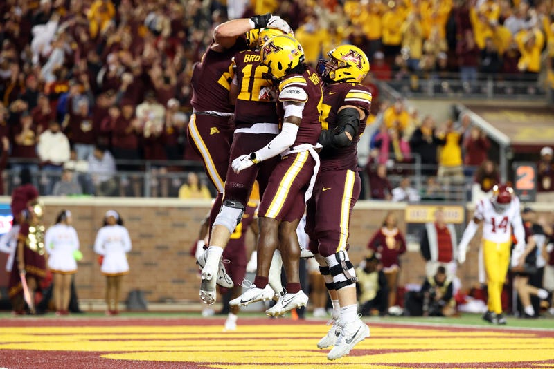 Max Brosmer #16 of the Minnesota Golden Gophers celebrates his touchdown with teammates in the fourth quarter at Huntington Bank Stadium on October 05, 2024 in Minneapolis, Minnesota. The Golden Gophers defeated the Trojans 24-17. 