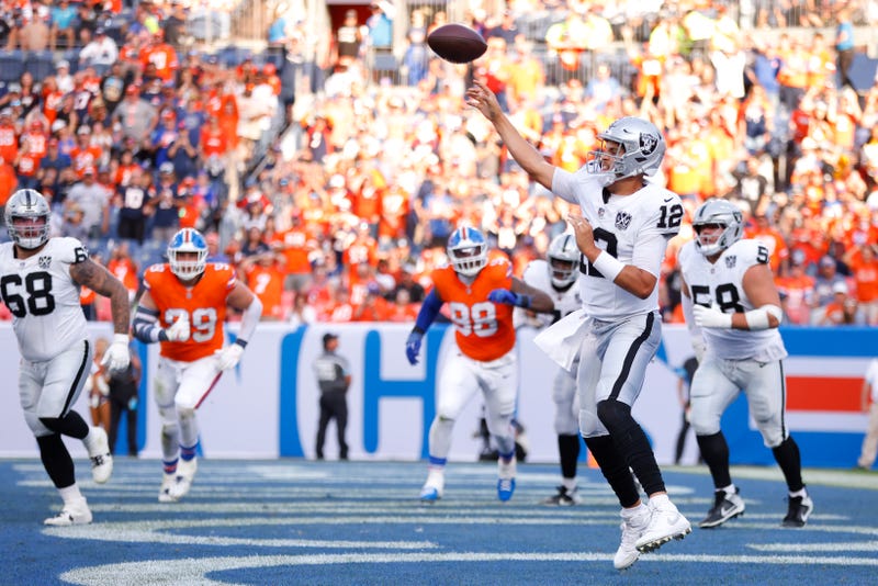 Aidan O'Connell #12 of the Las Vegas Raiders throws a pass against the Denver Broncos during the fourth quarter at Empower Field At Mile High on October 06, 2024 in Denver, Colorado.