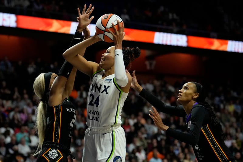 Napheesa Collier #24 of the Minnesota Lynx is double-teamed by DiJonai Carrington #21 and DeWanna Bonner #24 of the Connecticut Sun during the first half of Game Four of the WNBA playoff semifinals at Mohegan Sun Arena on October 6, 2024 in Uncasville, Connecticut.