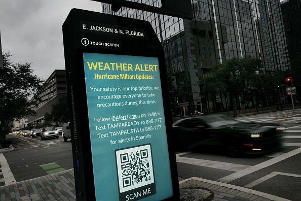 A weather alert is displayed along a sidewalk as Hurricane Milton churns in the Gulf of Mexico on October 07, 2024 in Tampa, Florida. 
