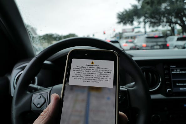 A weather alert is displayed on a phone as Hurricane Milton churns in the Gulf of Mexico on October 07, 2024 in Tampa, Florida. 