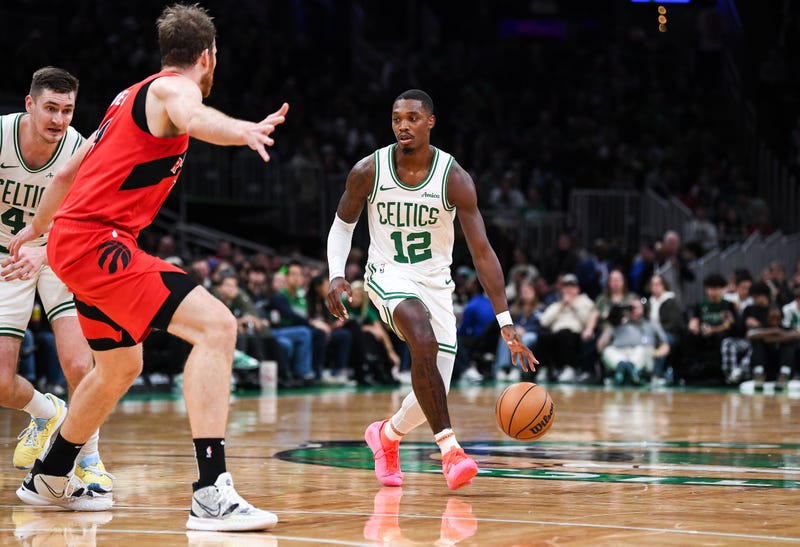 Lonnie Walker IV #12 dribbles the ball against the Toronto Raptors during a preseason game at TD Garden on October 13, 2024 in Boston, Massachusetts