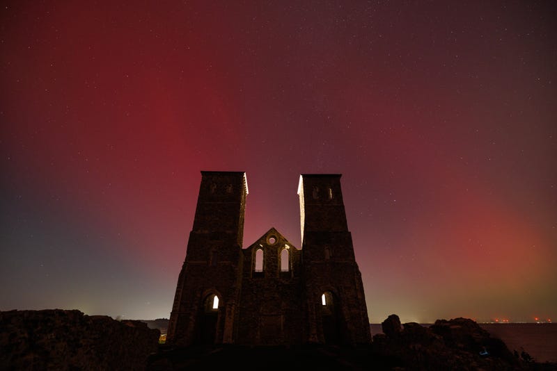 HERNE BAY, UNITED KINGDOM - OCTOBER 11: The aurora borealis light up the night sky behind the Reculver Towers and Roman Fort on October 11, 2024 in Herne Bay, United Kingdom. The Aurora Borealis or Northern Lights result from geomagnetic storms and were seen as far southern england overnight on the 10th October. (Photo by Dan Kitwood/Getty Images)