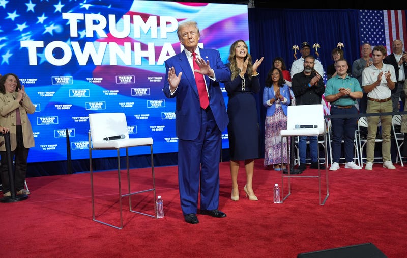 Former President Donald Trump dances on stage with South Dakota Gov. Kristi Noem during a town hall event held at the Greater Philadelphia Center & Fairgrounds, in Oaks, Pa. on Monday, Oct. 14, 2024.