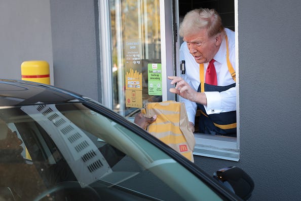 Republican presidential nominee, former U.S. President Donald Trump works the drive-through line as he visits a McDonald's restaurant on October 20, 2024 in Feasterville-Trevose, Pennsylvania. 