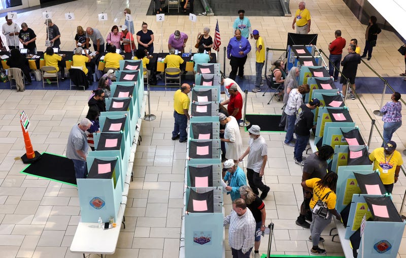  Clark County Election Department poll workers check in voters at a table as people vote at the Meadows Mall on October 21, 2024 in Las Vegas, Nevada. Early voting in the battleground state began on October 19 and continues through November 1. 