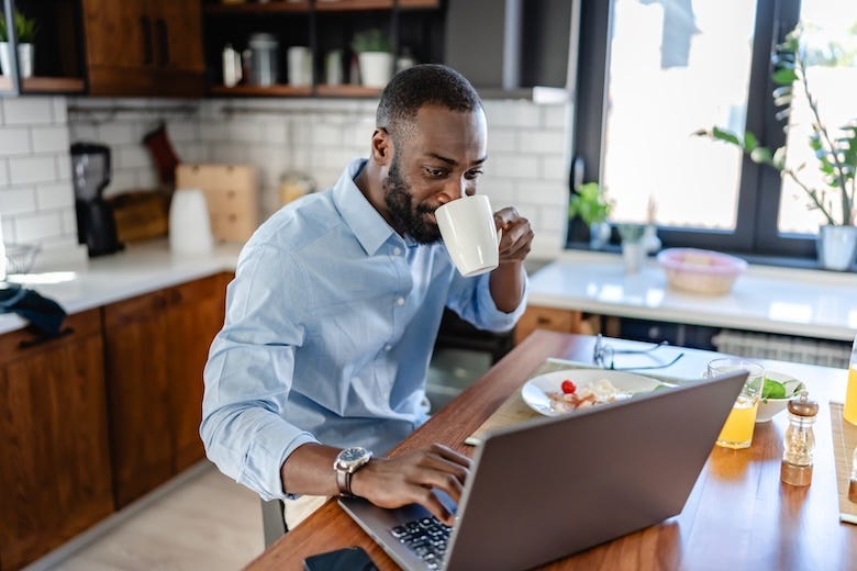 Remote worker on his computer in the kitchen