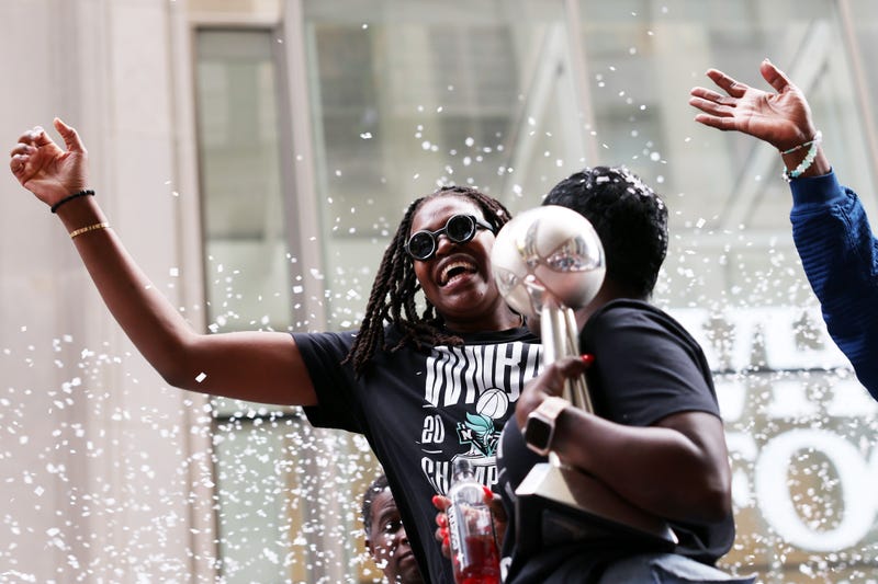 Jonquel Jones #35 of the New York Liberty carries the MVP trophy while waving to the crowd during the New York Liberty Ticker Tape Victory Parade & Rally on October 24, 2024 in New York City