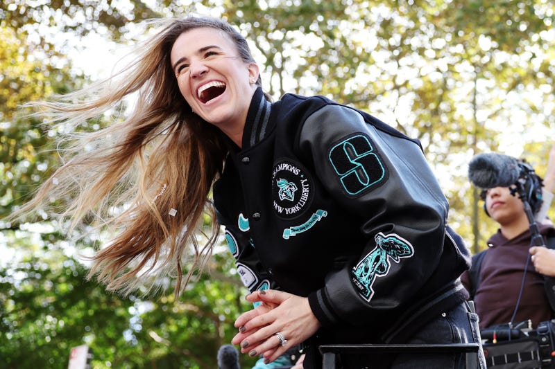 Sabrina Ionescu #20 of the New York Liberty waves to the crowd during the New York Liberty Ticker Tape Victory Parade & Rally on October 24, 2024 in New York City