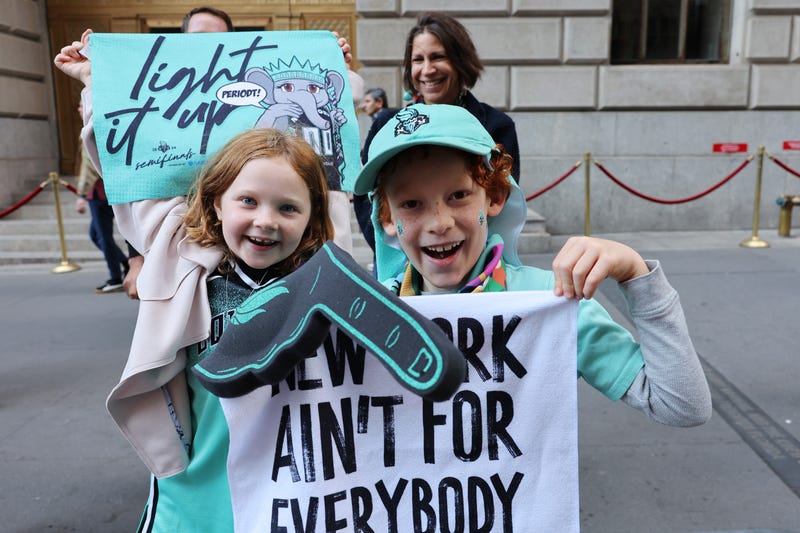 New York Liberty fans Haley De Leon and Ezra Hollar-Steinfeld wait for the start of their WNBA championship parade on Broadway on October 24, 2024