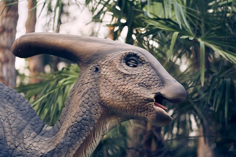 A giant parasaurolophus on display in the park on a sunny summer day