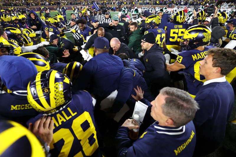 Michigan and Michigan State players clash after game