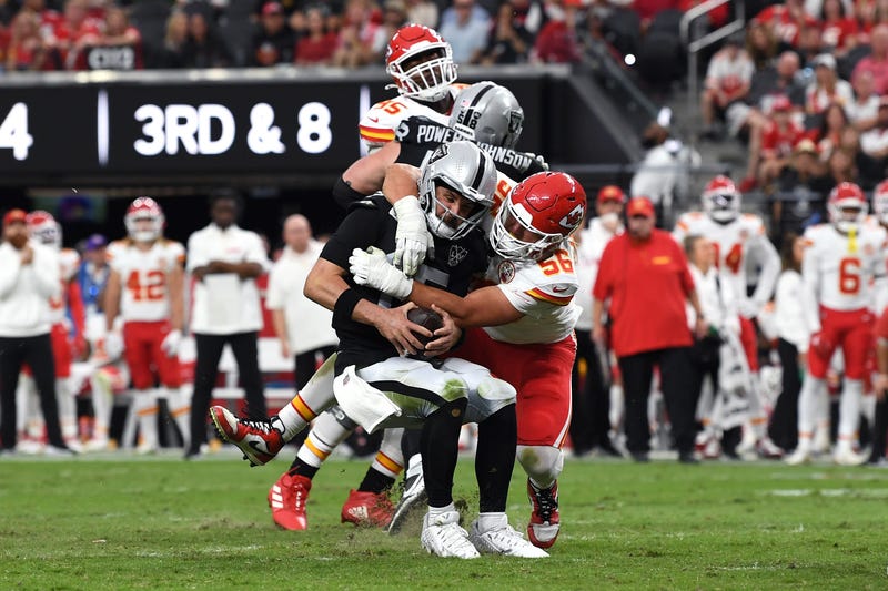 Gardner Minshew #15 of the Las Vegas Raiders is sacked by George Karlaftis #56 of the Kansas City Chiefs during the third quarter at Allegiant Stadium on October 27, 2024 in Las Vegas, Nevada