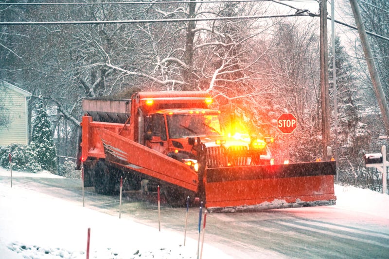 A snowplow working on a snowy street