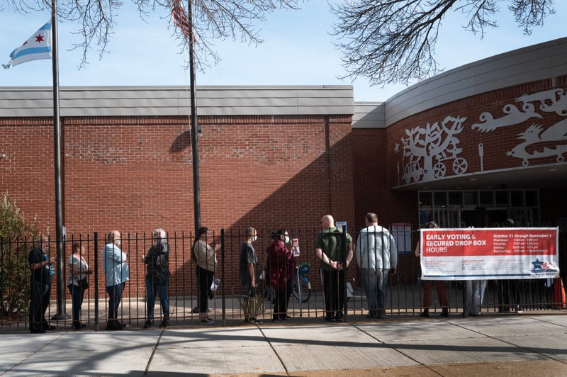 Residents wait in line to vote at an early-voting location in Chicago's  Humboldt Park neighborhood.
