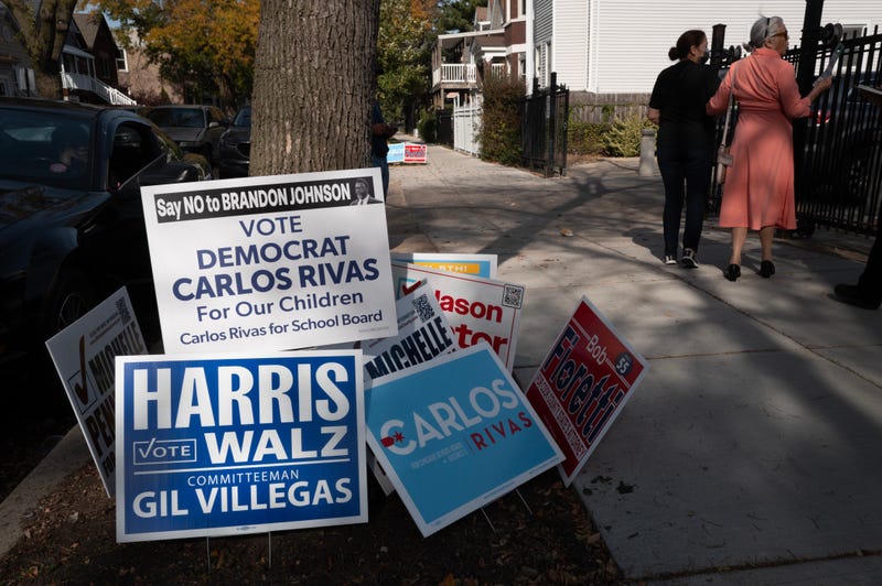 Campaign signs are posted near an early-voting location in the Humboldt Park neighborhood on Oct. 29, 2024.