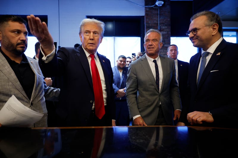 Republican President-election Donald Trump visits with Robert F. Kennedy Jr (center R) in Dearborn, Michigan. 