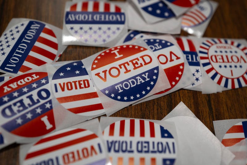 Stickers sit on a table during in-person absentee voting on November 01, 2024