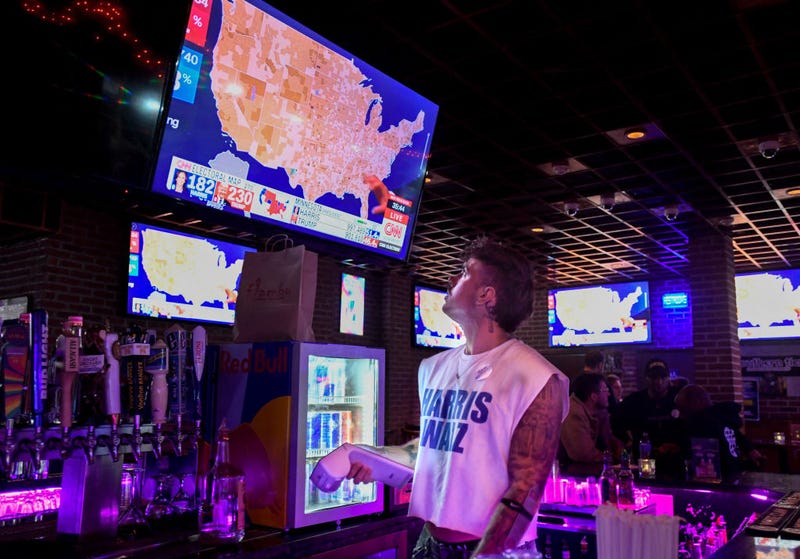 A bartender watches election results at Woody's, a bar in Philadelphia's Gayborhood, on Tuesday night.
