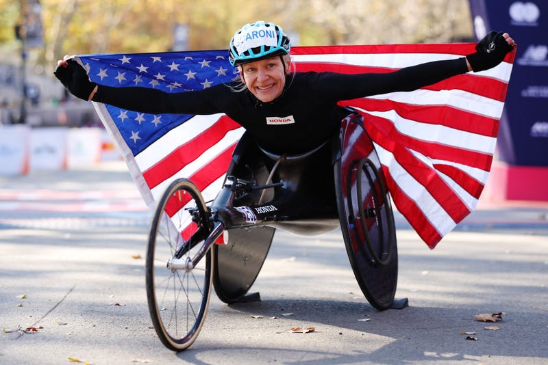 Susannah Scaroni of the United States poses with the flag after winning the Professional Women’s Wheelchair Division during the 2024 TCS New York City Marathon on Nov. 3, 2024 in New York City. 