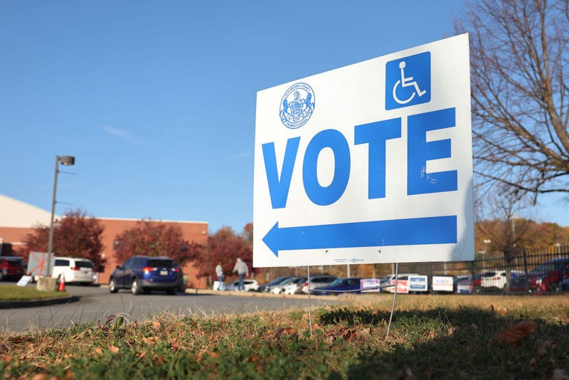 A "Vote" sign is seen as people arrive to vote on Election Day