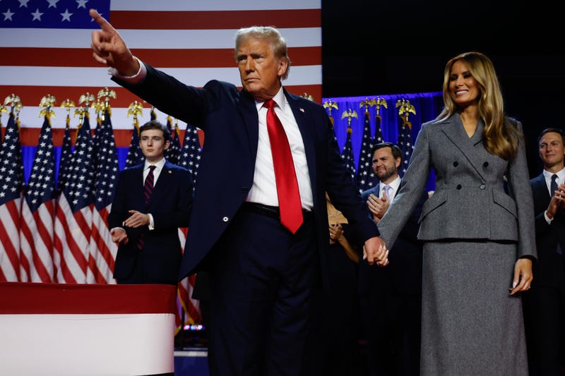 Republican presidential nominee, former U.S. President Donald Trump points to supporters with former first lady Melania Trump during an election night event at the Palm Beach Convention Center on November 06, 2024 in West Palm Beach, Florida. Americans cast their ballots today in the presidential race between Republican nominee former President Donald Trump and Vice President Kamala Harris, as well as multiple state elections that will determine the balance of power in Congress.