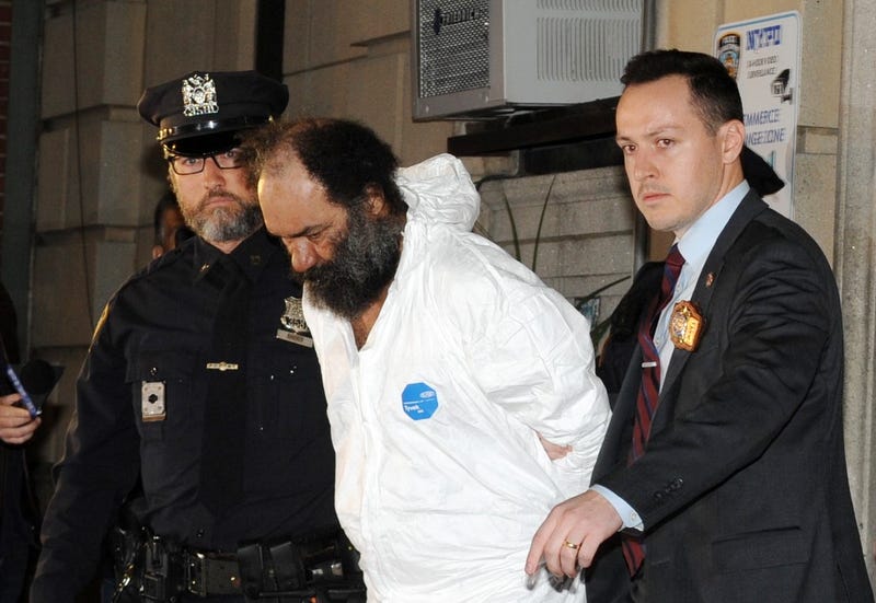 Ramon Rivera, 51, having been charged with three stabbing murders, is pictured in police custody leaving the NYPD's 10th Precinct stationhouse on Monday, Nov. 18, 2024