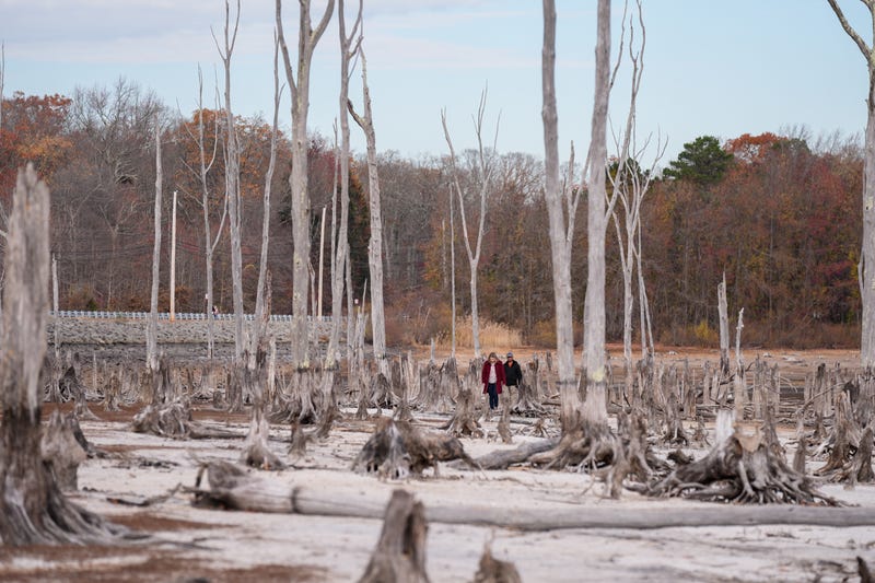 People walk this week in the bone-dry Manasquan Reservoir, which supplies water to 1.2 million people in New Jersey