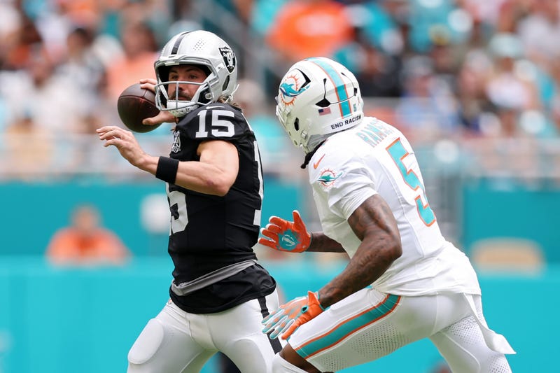 Gardner Minshew #15 of the Las Vegas Raiders looks to pass while pressured by Jalen Ramsey #5 of the Miami Dolphins in the second quarter of a game at Hard Rock Stadium on November 17, 2024 in Miami Gardens, Florida.