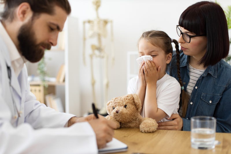 Pediatrician with sick child and her mother
