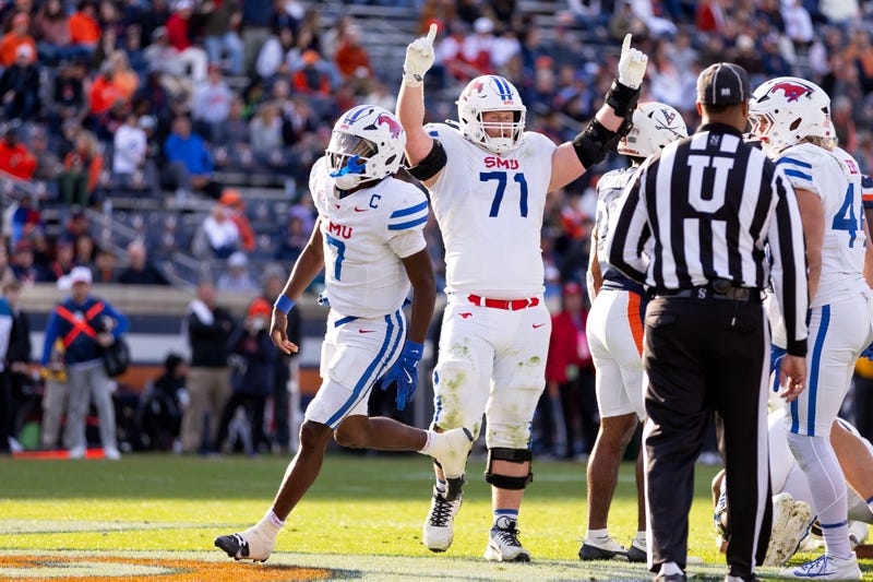 Kevin Jennings #7 and Logan Parr #71 of the Southern Methodist Mustangs celebrate a touchdown in the second half during a game against the Virginia Cavaliers at Scott Stadium on Nov. 23, 2024, in Charlottesville, Virginia.