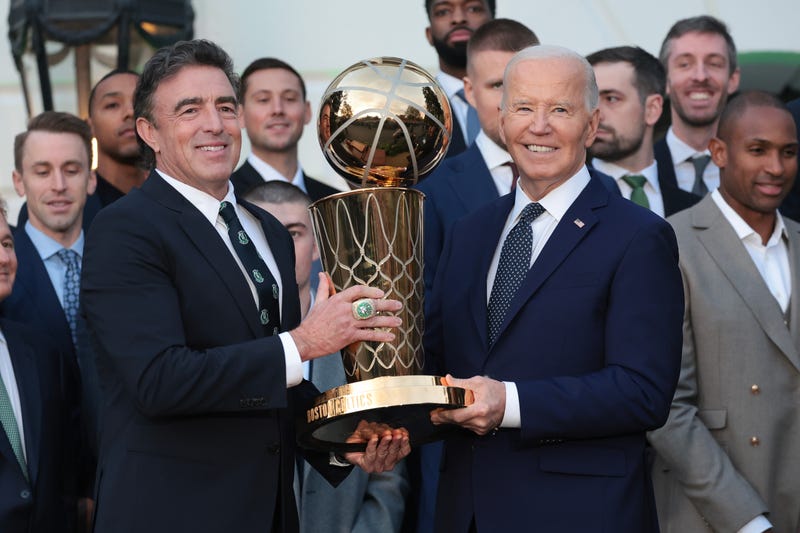 U.S. President Joe Biden and Boston Celtics owner Wyc Grousbeck (L) hold up the NBA Championship trophy as Biden welcomed the 2024 NBA Champion Boston Celtics to the White House November 21, 2024 in Washington, DC.