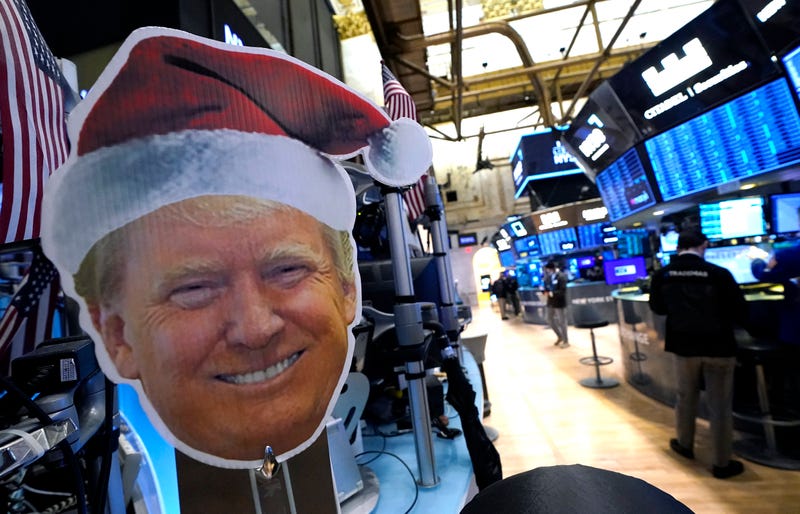 President-elect Donald Trump is displayed as traders work on the floor of the New York Stock Exchange (NYSE) at the opening bell