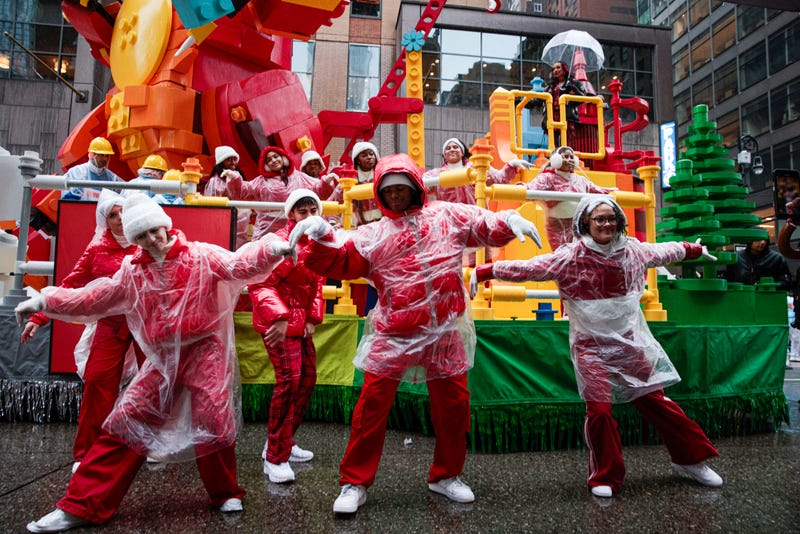 A reveller fix the dress from a mate as they march during the Annual Thanksgiving Day Parade on November 28, 2024 in New York City. This is the 98th Macy's Thanksgiving Day Parade which was first held in 1924 and only paused from 1942 to 1944 during World War II. 