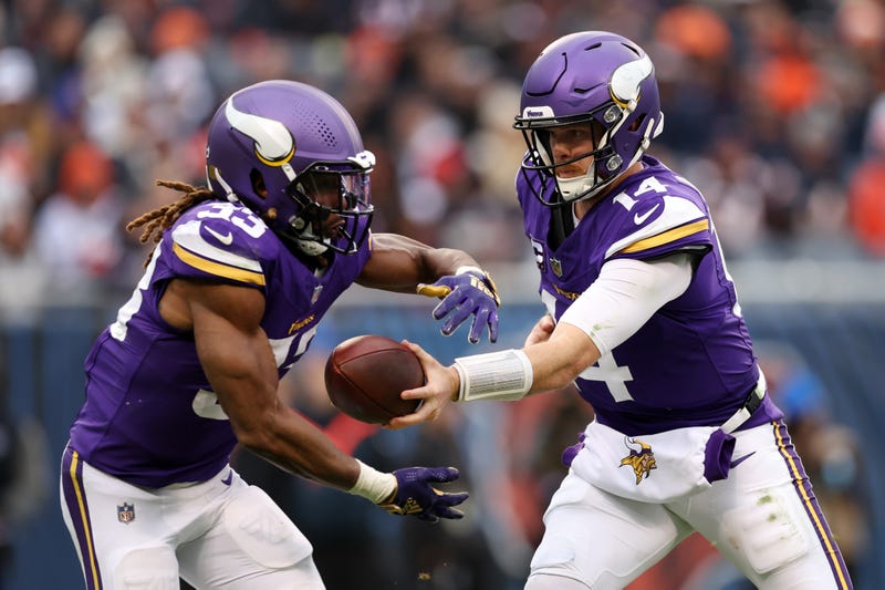 Sam Darnold #14 of the Minnesota Vikings hands off to Aaron Jones #33 during the third quarter against the Chicago Bears at Soldier Field on November 24, 2024 in Chicago, Illinois. 