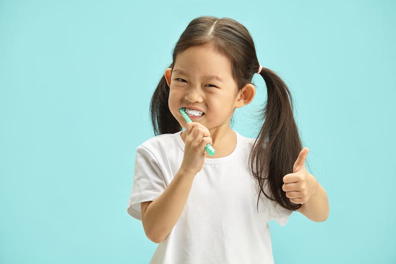 Child brushes her teeth