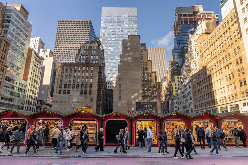 People walk past a Christmas market on 5th Avenue on Nov. 29, 2024 in New York City. Black Friday sales will give economists a glimpse into consumers' holiday shopping mood. 