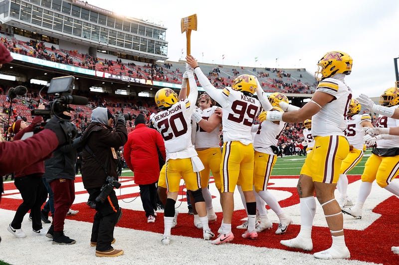 Minnesota Golden Gophers players celebrates with the Ax after a win over the Wisconsin Badgers at Camp Randall Stadium on November 29, 2024 in Madison, Wisconsin. 