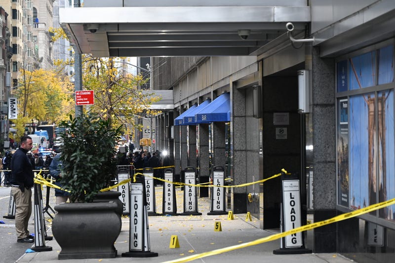 Police officers investigate the scene where UnitedHealthcare CEO Brian Thompson was fatally shot in Midtown Manhattan near the New York Hilton on 54th Street between 6th and 7th avenues on Dec. 4, 2024