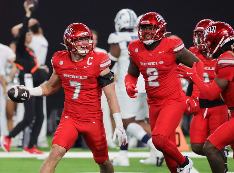Linebacker Jackson Woodard #7 of the UNLV Rebels celebrates with teammates after he recovered a Nevada Wolf Pack fumble in the end zone for a touchdown in the second quarter of their game at Allegiant Stadium on November 30, 2024 in Las Vegas, Nevada.
