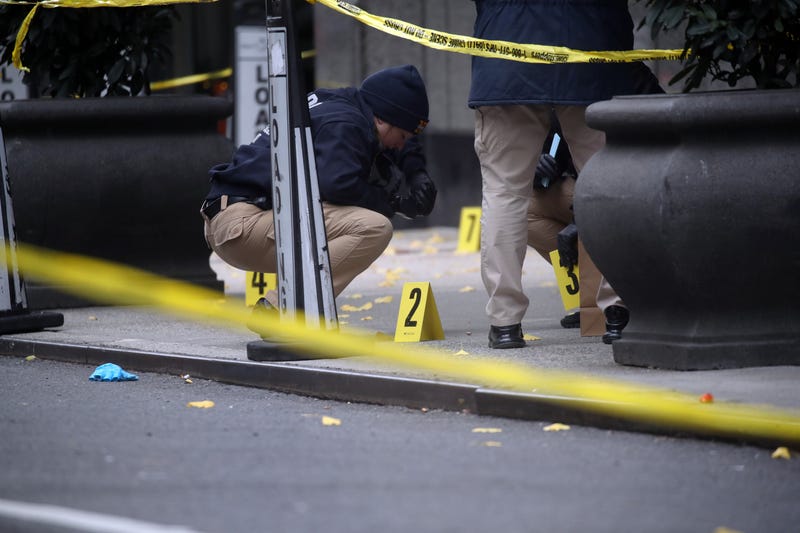 Police place bullet casing markers outside of a Hilton Hotel in Midtown Manhattan where United Healthcare CEO Brian Thompson was fatally shot on December 04, 2024 in New York City. 