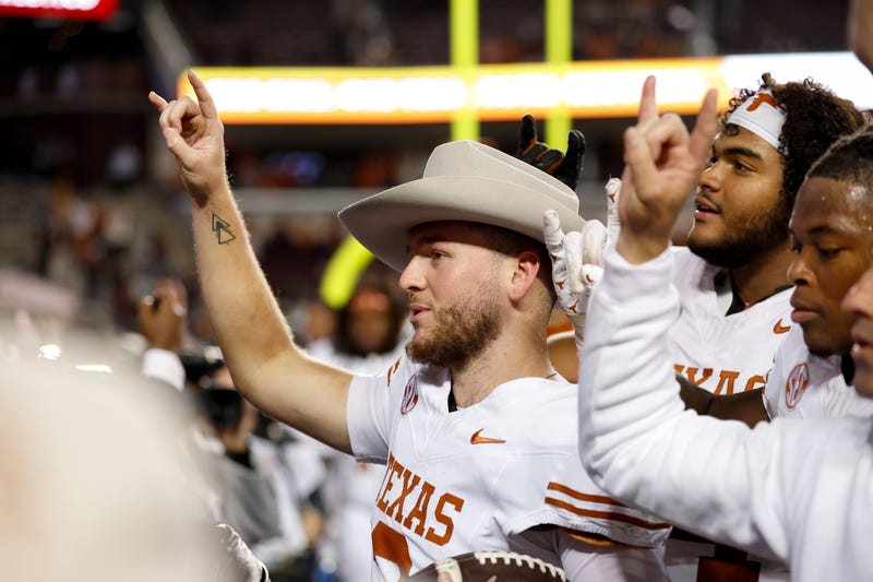 Quinn Ewers #3 of the Texas Longhorns celebrates with teammates after the game against the Texas A&M Aggies at Kyle Field on Nov. 30, 2024, in College Station, Texas.