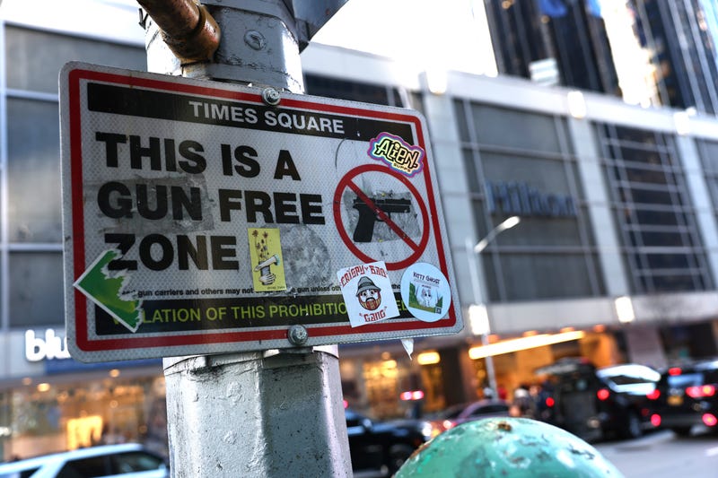 A "Gun Free Zone" sign is seen near the Midtown Hilton on Dec. 6, 2024