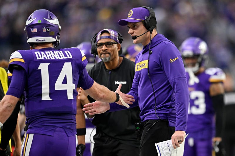 Sam Darnold #14 celebrates after throwing a touchdown pass with head coach Kevin O'Connell at U.S. Bank Stadium.