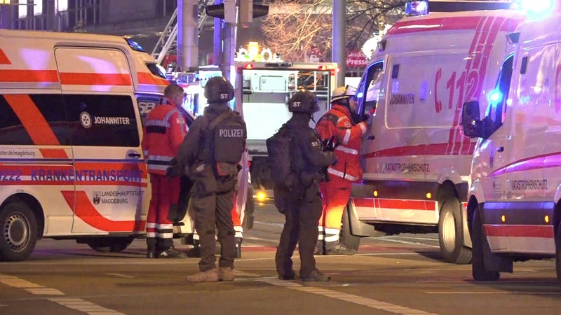Police and ambulances stand next to the Christmas marke