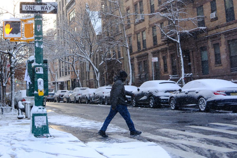 A man crosses a street in Manhattan on Dec. 21, 2024.