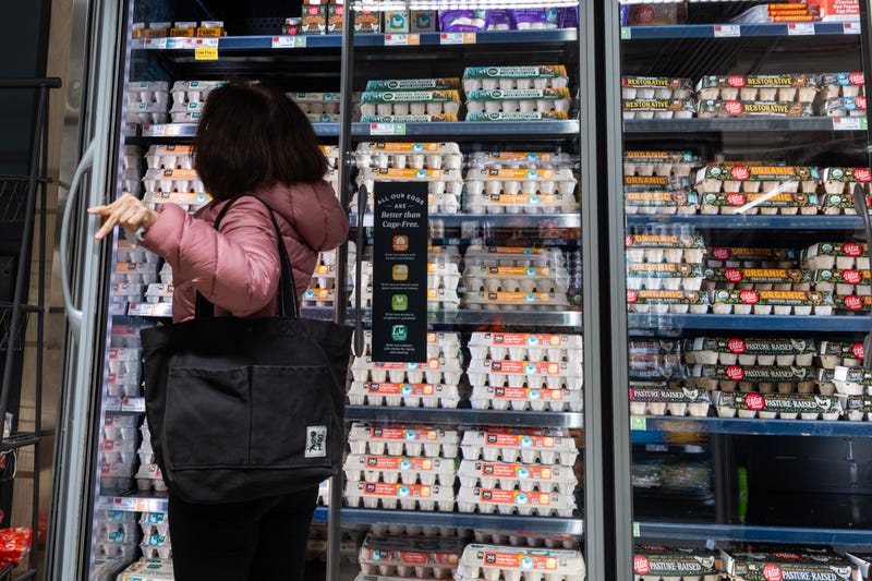 A person shops for eggs at a Whole Foods Market grocery store in New York City. 